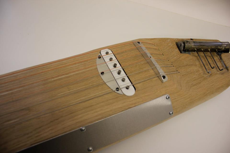 Experimental zither by Irish instrument designer Ed Devane. Made of Oak, and featuring two thumb pianos
