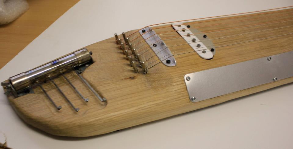 Experimental zither by Irish instrument designer Ed Devane. Made of Oak, and featuring two thumb pianos
